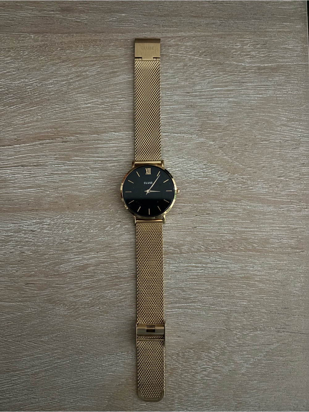 Cluse gold watch with black face